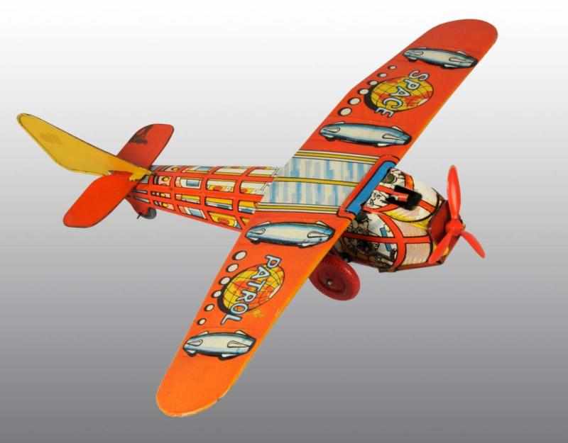 Appraisal: Tin Space Patrol Airplane Flywheel Toy Description English Working Plastic