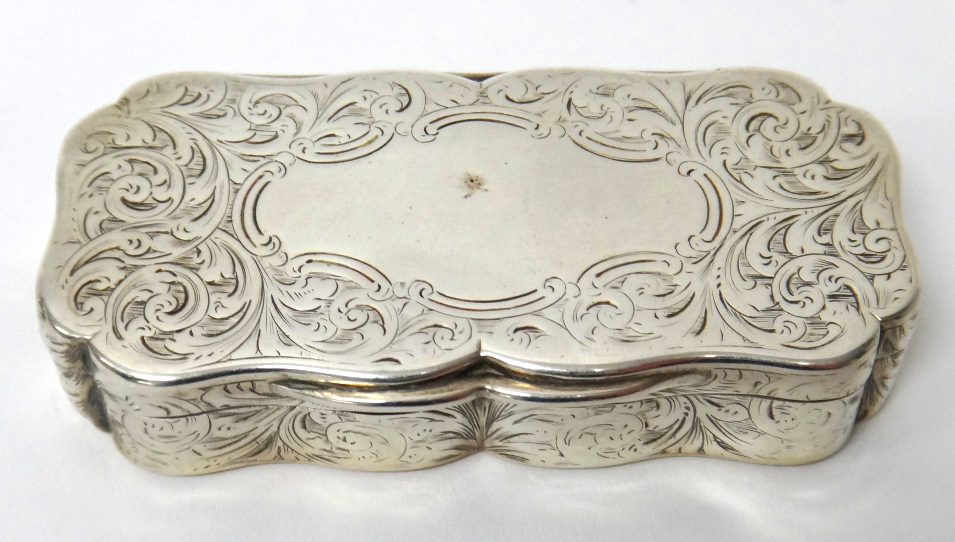 Appraisal: A Victorian silver shaped rectangular snuff box the exterior with