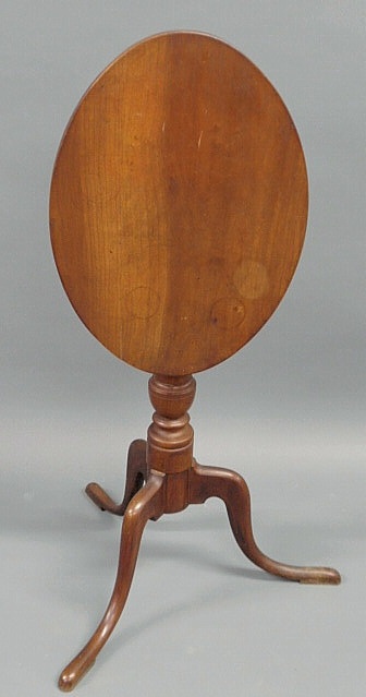 Appraisal: Cherry candlestand with an oval top urn turned shaft and