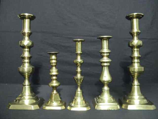 Appraisal: Five early brass candlesticks Includes two '' tall matching candlesticks