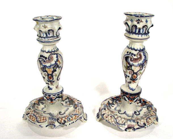 Appraisal: Pair of French Faience glazed candlesticks hand painted and relief