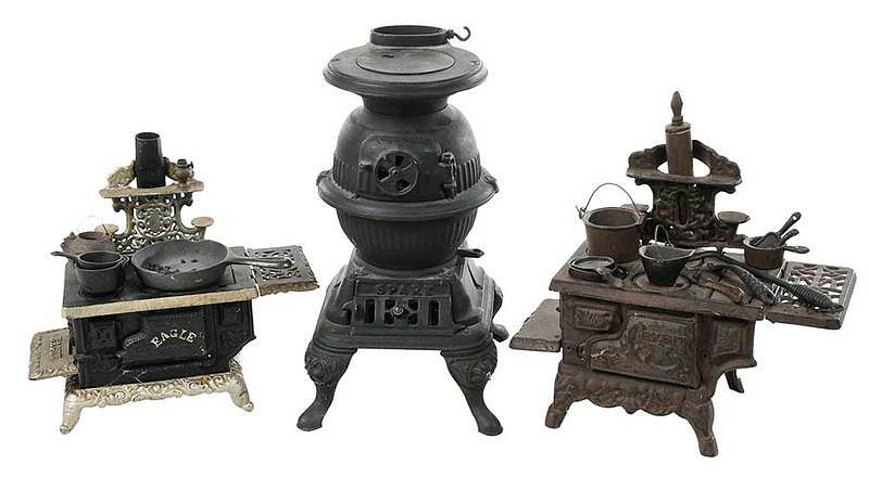 Appraisal: Three Miniature Cast Iron Stoves and Accessories American late th