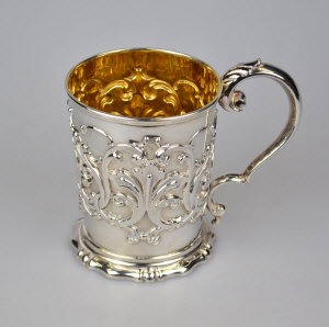 Appraisal: A Victorian tapering Christening mug with foliate and scroll embossed