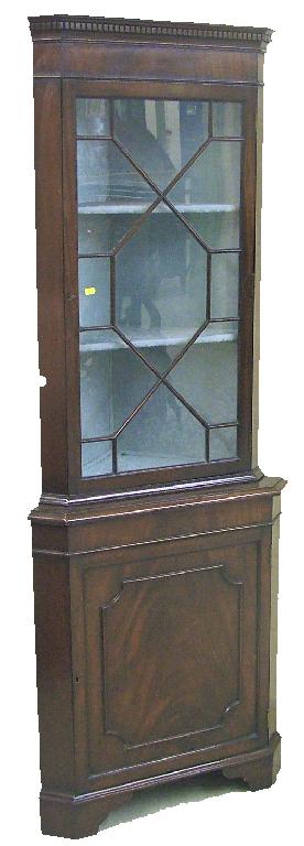 Appraisal: Georgian style mahogany standing corner display cabinet the carved dentil