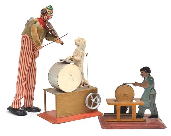 Appraisal: TINPLATE CLOCKWORK CLOWN PLAYING VIOLIN DOG WITH DRUM AND CYMBALS