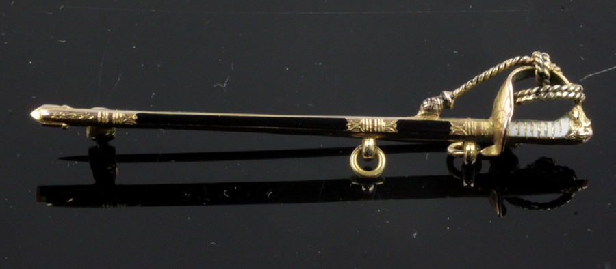 Appraisal: A gold and enamel pin of Naval sword form the