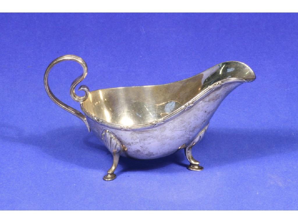 Appraisal: A SAUCEBOAT of oval form with a reeded scroll handle