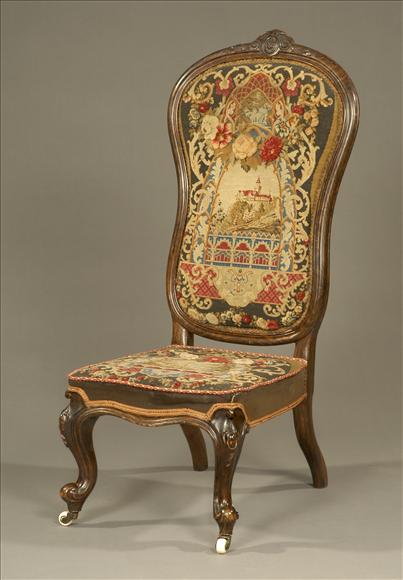 Appraisal: A walnut nursing chair circa the tall cartouche shaped back