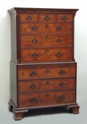 Appraisal: A WALNUT CHEST ON CHEST with feather banding cavetto moulded