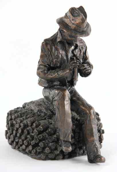 Appraisal: Figural Sculpturecomposition seated gentleman on tobacco in