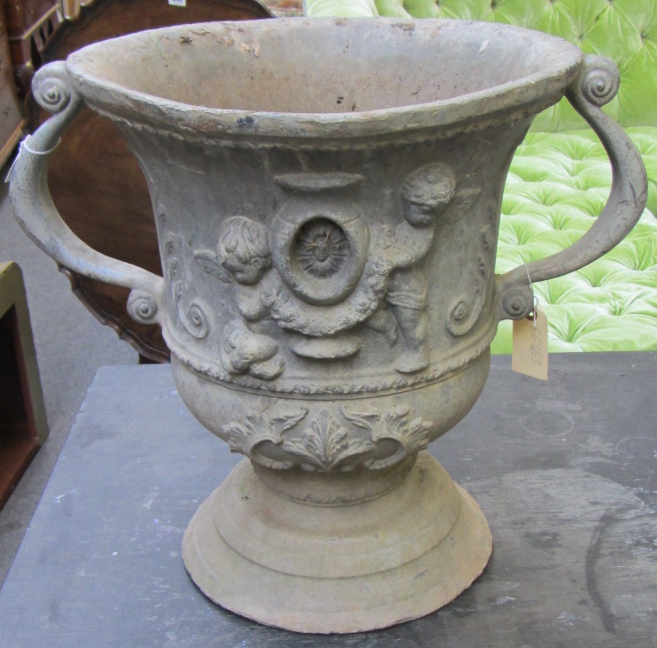 Appraisal: A pair of lead urns each of twin handle baluster