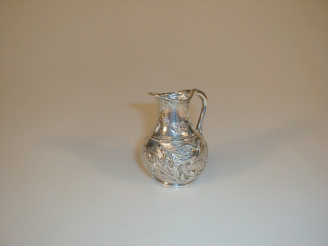 Appraisal: A Victorian silver cream jug of baluster form embossed in