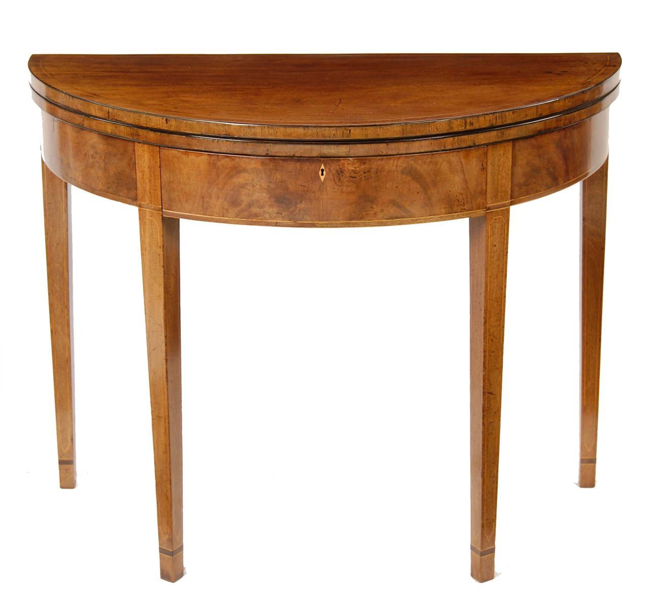 Appraisal: A George III mahogany demi-lune fitted tea table