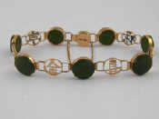 Appraisal: A Chinese yellow metal tests carat gold nephrite jade bracelet