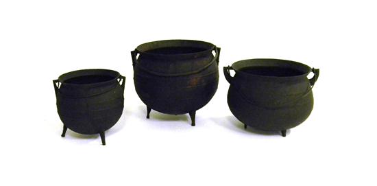 Appraisal: Three iron tripod base cooking pots graduated sizes largest is