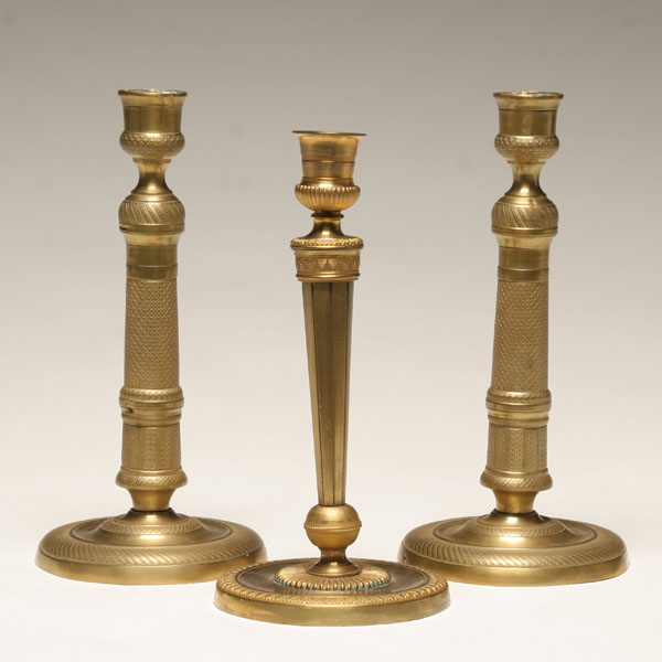 Appraisal: Three antique engraved brass candlesticks one pair with star in