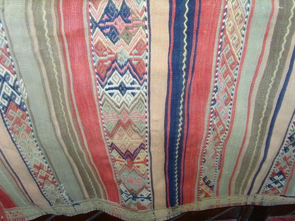 Appraisal: A flat woven rug with striped decoration in pink green