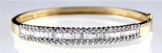 Appraisal: Diamond and gold bangle bracelet baguette and round diamonds approx