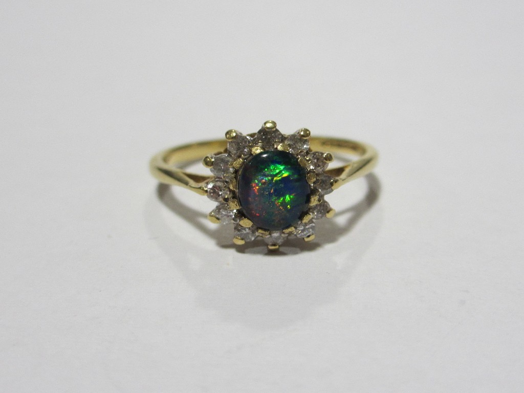 Appraisal: Eighteen carat gold black opal doublet and diamond cluster ring