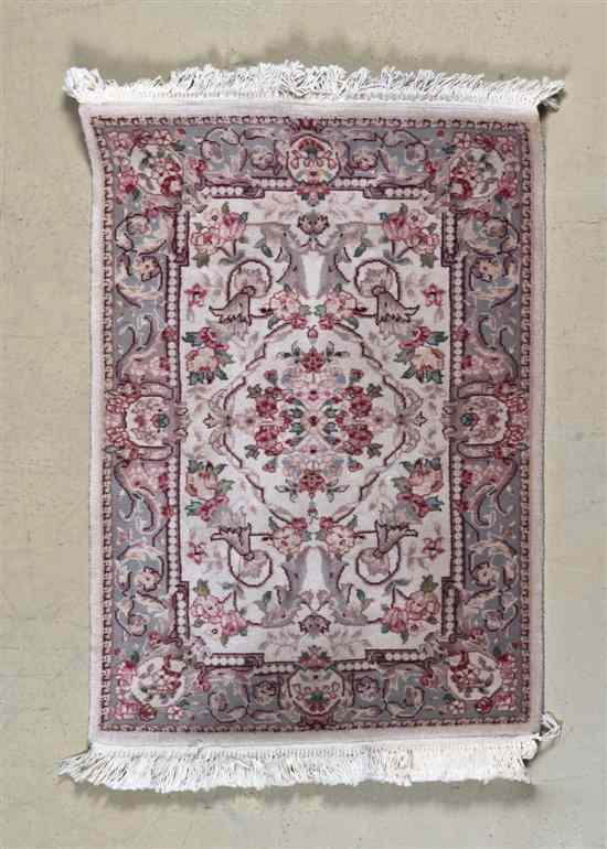 Appraisal: A Persian Wool Rug decorated with flowering plants on an