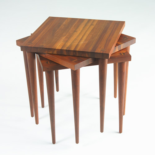 Appraisal: PHILLIP LLOYD POWELL Set of three walnut nesting tables with