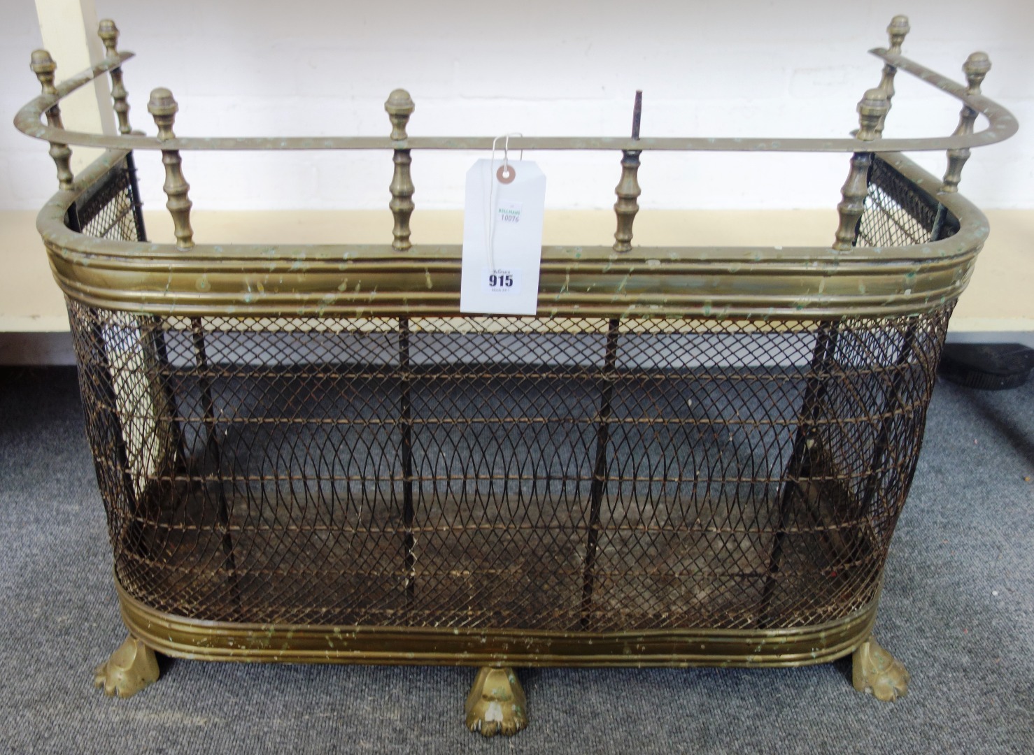 Appraisal: A late Victorian brass and blacked mesh nursery fender surmounted