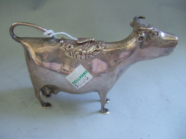 Appraisal: A silver cow creamer of standing form the back with