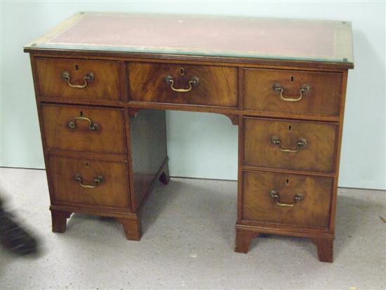 Appraisal: th century mahogany kneehole desk with red leather inset top