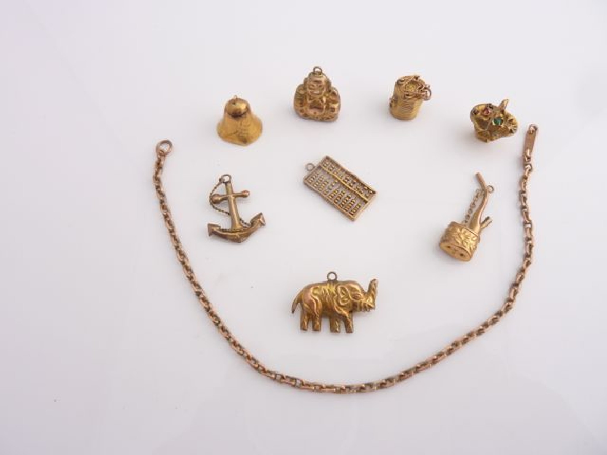 Appraisal: A collection of eight ct gold charms including an elephant