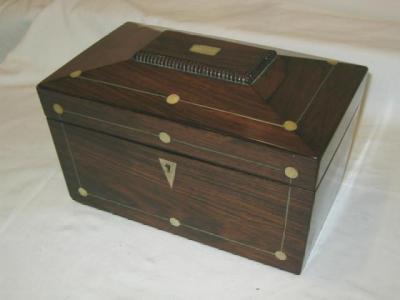 Appraisal: A ROSEWOOD TEA CADDY of sarcophagus form with pewter stringing