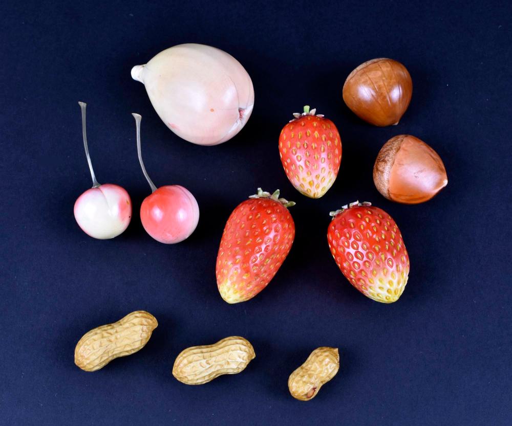 Appraisal: ELEVEN CHINESE POLYCHROME CARVED FRUITS NUTSComprising a fig three strawberries