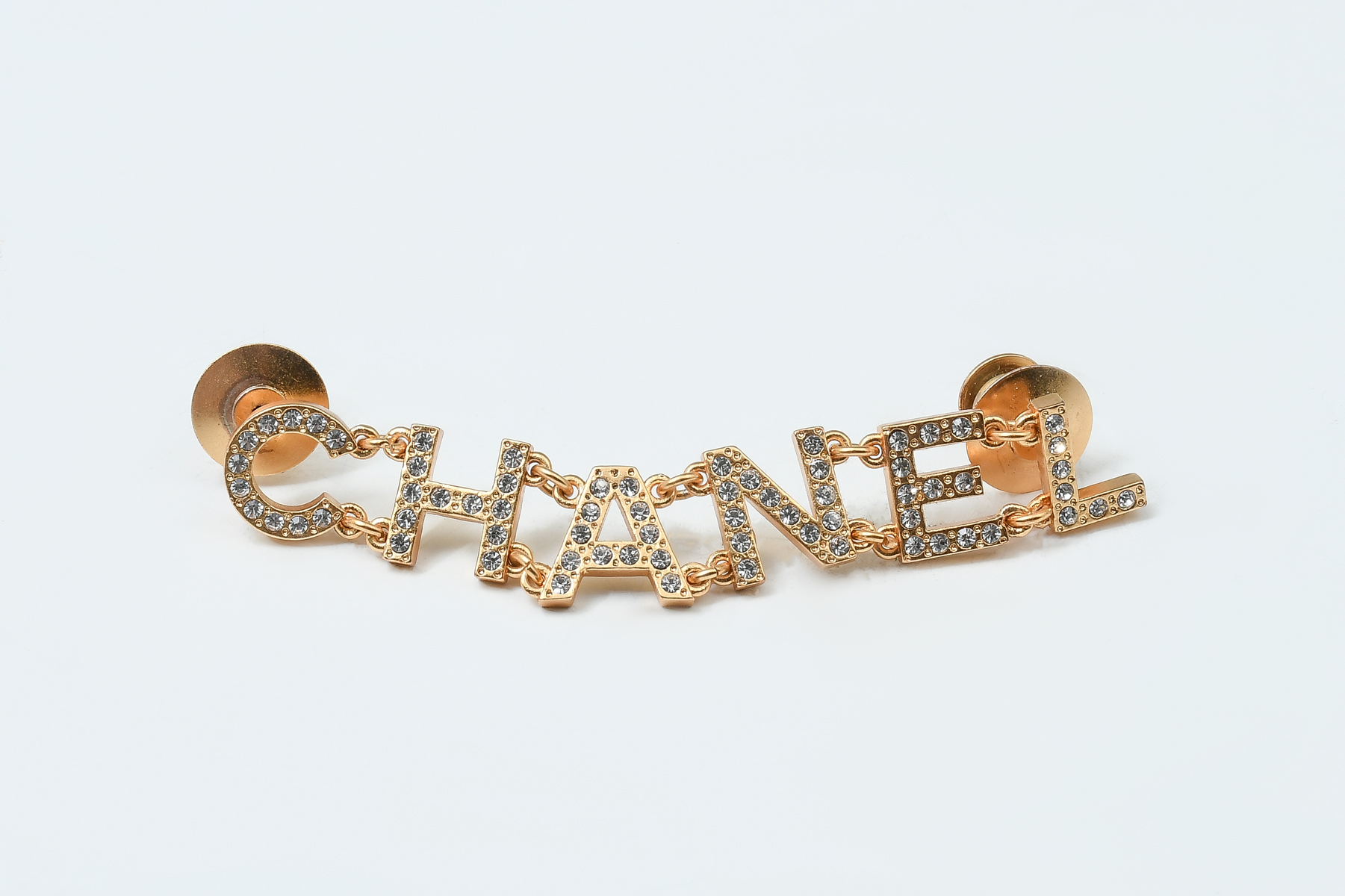 Appraisal: CHANEL LOGO BROOCH PIN WITH RHINESTONES Wonderful collectible CHANEL gold