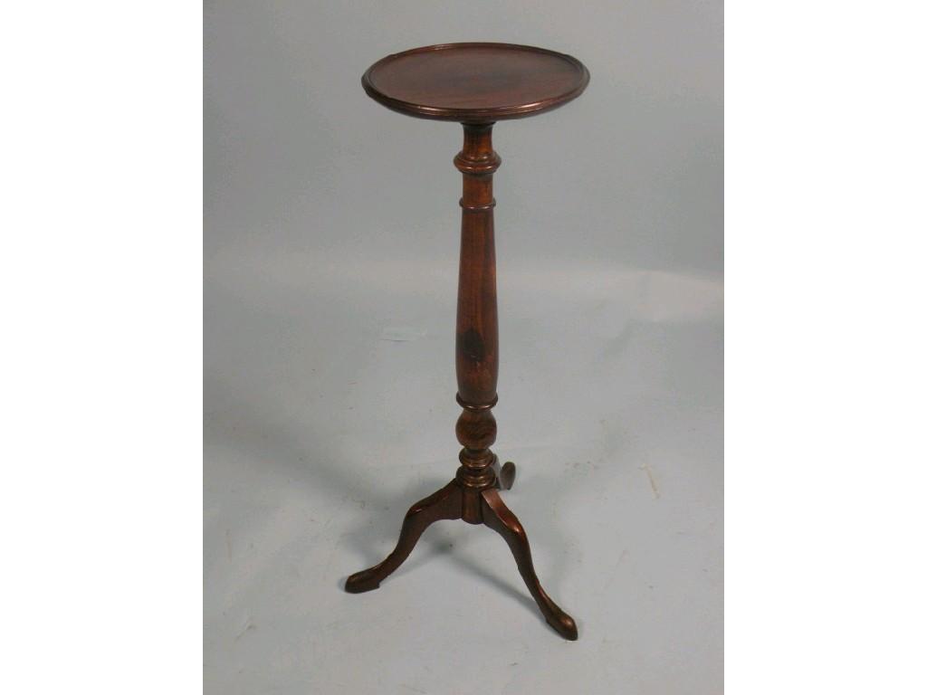 Appraisal: A mahogany and stained beech plant stand on a tripod