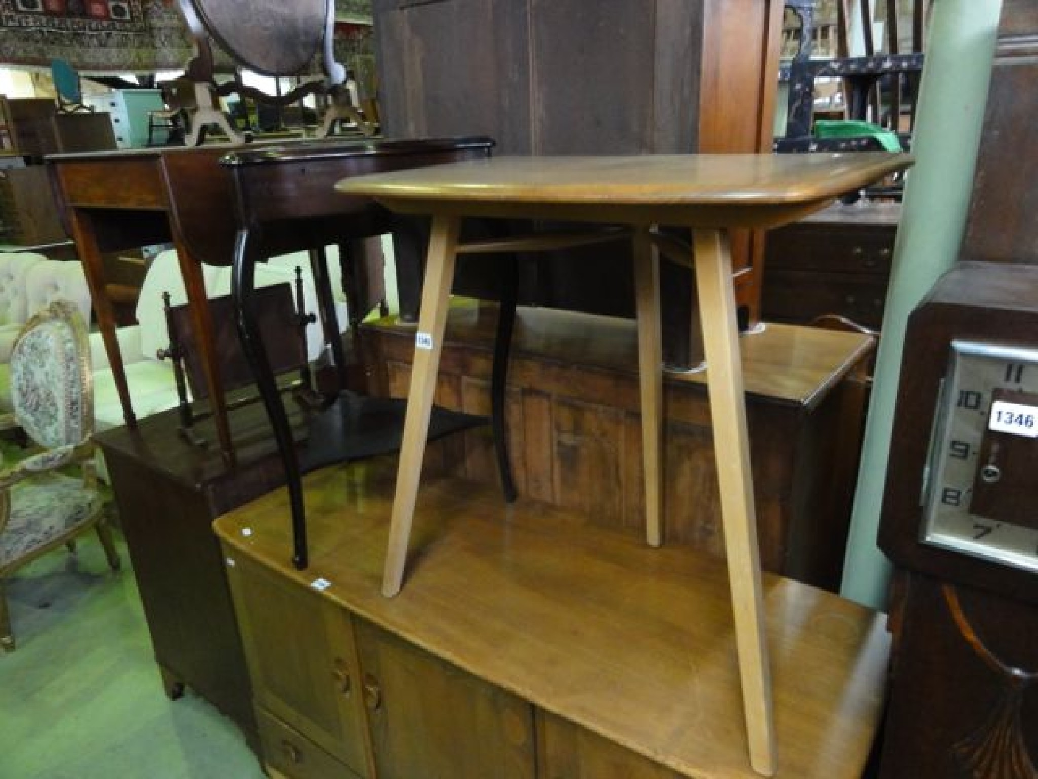 Appraisal: An Ercol elm and beechwood extension occasional table raised on