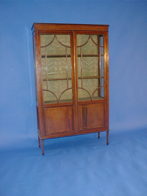 Appraisal: An Edwardian cross banded mahogany display cabinet with two astragal