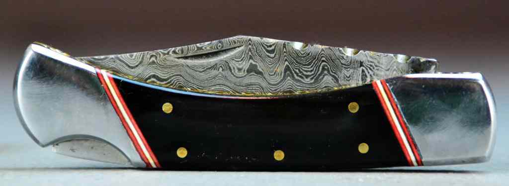 Appraisal: Damascus Blade Folding KnifeWith polished and dyed bone handle fitted