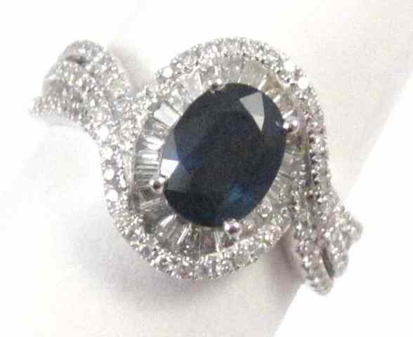 Appraisal: SAPPHIRE DIAMOND AND FOURTEEN KARAT GOLD RING round-cut diamonds surround