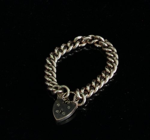 Appraisal: A ct gold curb link bracelet with heart-shaped padlock clasp