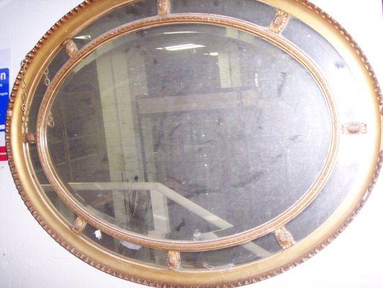 Appraisal: An oval gilt plaster wall mirror with surround of oval