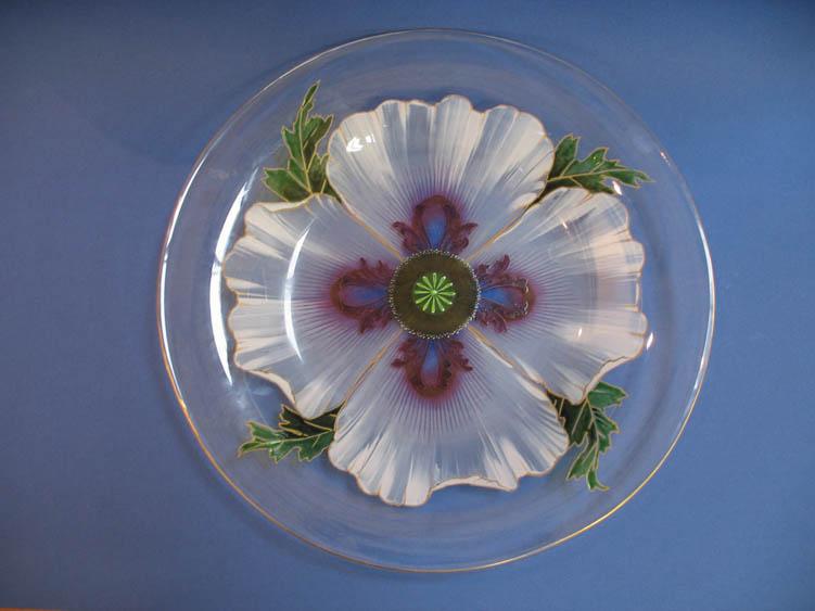 Appraisal: A CIRCULAR GLASS PLATE decorated in enamels with a flowerhead