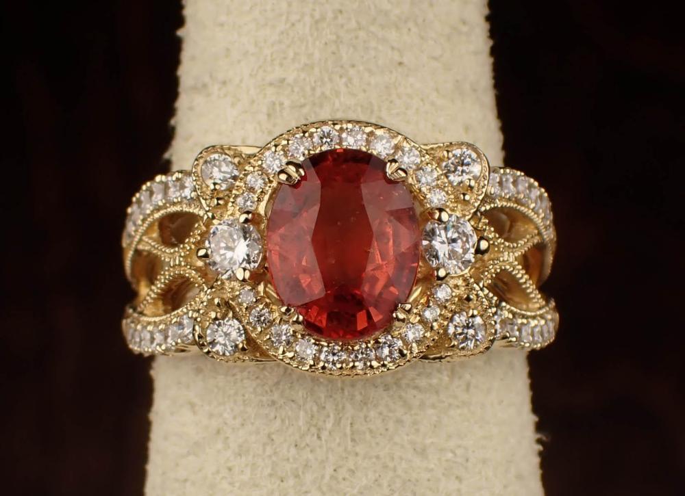 Appraisal: ORANGE SAPPHIRE DIAMOND AND FOURTEEN KARAT GOLD RING The yellow