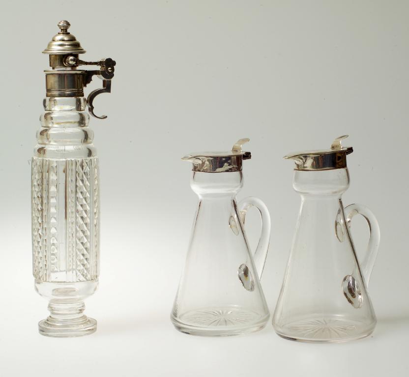 Appraisal: PAIR OF EDWARDIAN SILVER-MOUNTED GLASS WHISKY TOTS MAPPIN WEBB BIRMINGHAM