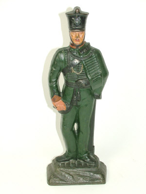 Appraisal: A painted cast iron door stop moulded as a rifleman