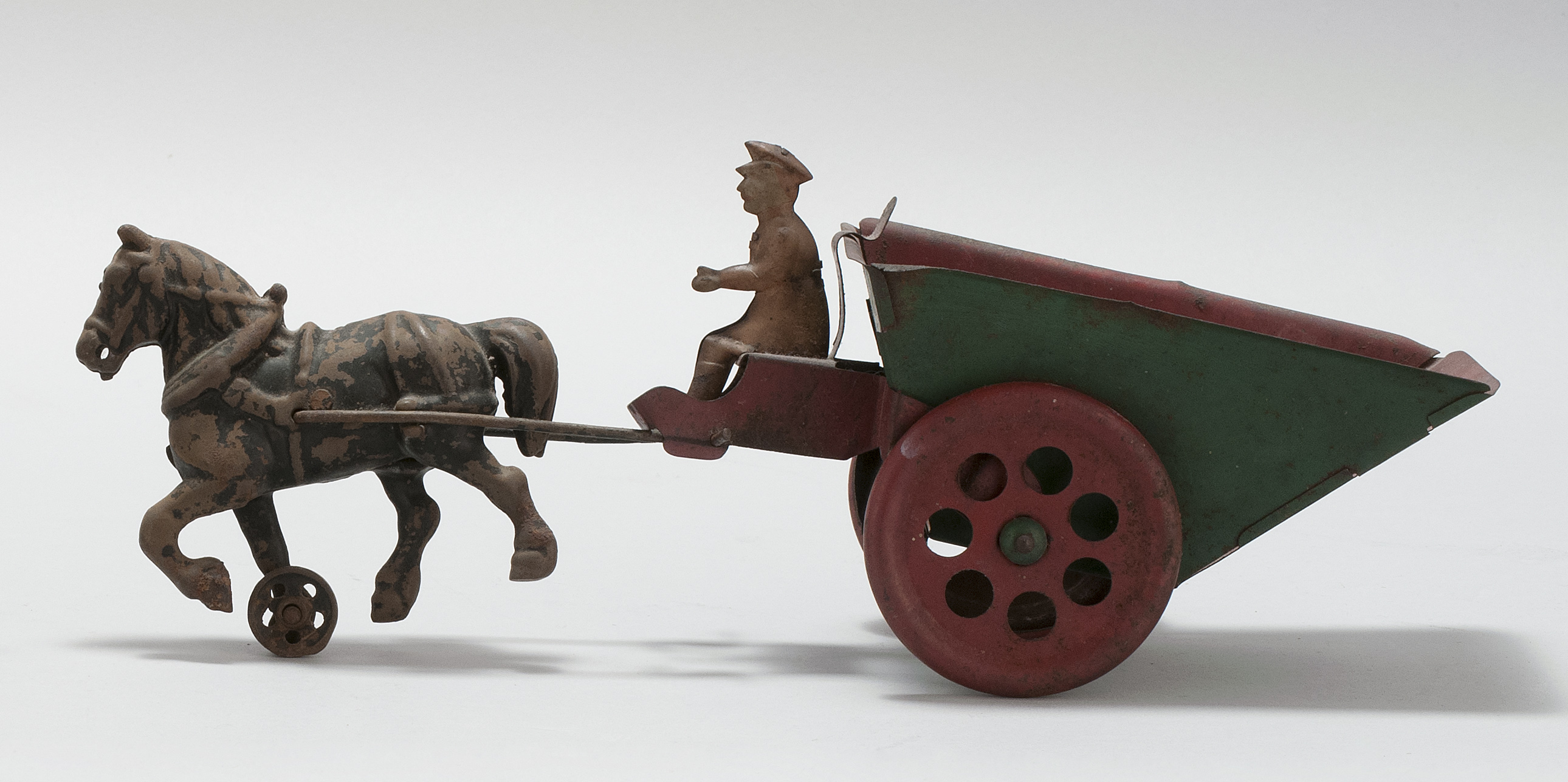 Appraisal: CAST IRON AND TIN HORSE-DRAWN DUMP WAGON TOY American Circa