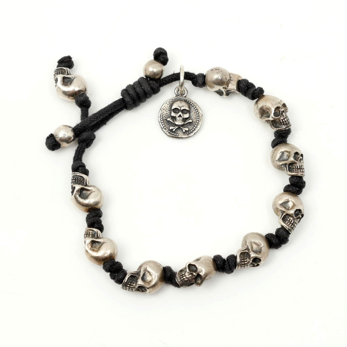 Appraisal: KING BABY KNOTTED CORD STERLING SKULL BRACELET Knotted waxed cotton