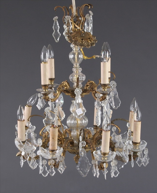 Appraisal: CONTINENTAL TWO-TIER GILT-METAL AND CRYSTAL TWELVE-LIGHT CHANDELIER th century Foliate