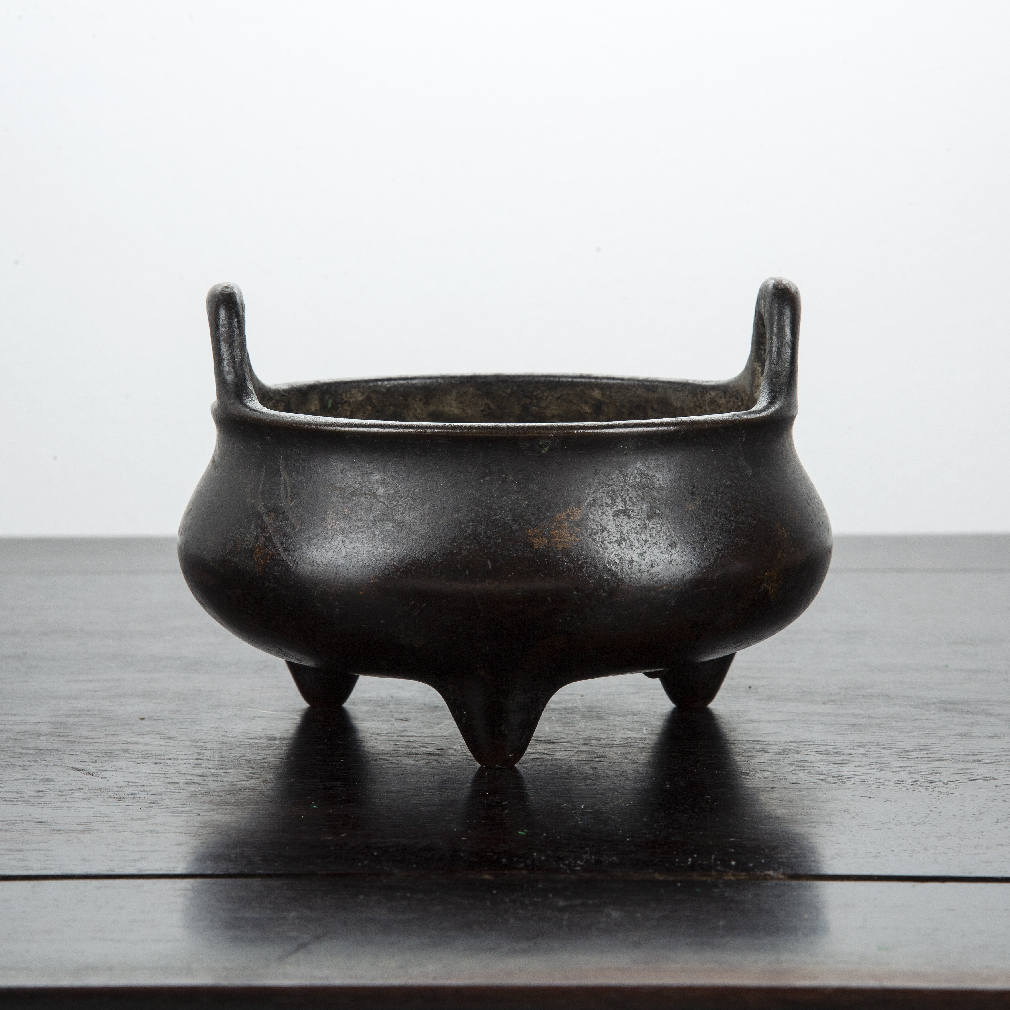 Appraisal: Bronze censer dingChinese th Century with loop handles on three