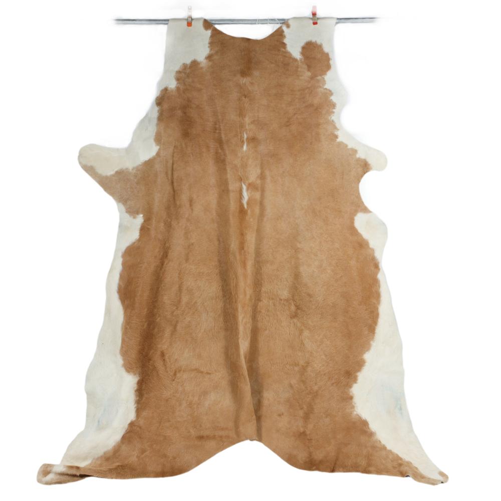 Appraisal: LARGE BROWN AND WHITE TANNED COW HIDE COWHIDE FUR RUG