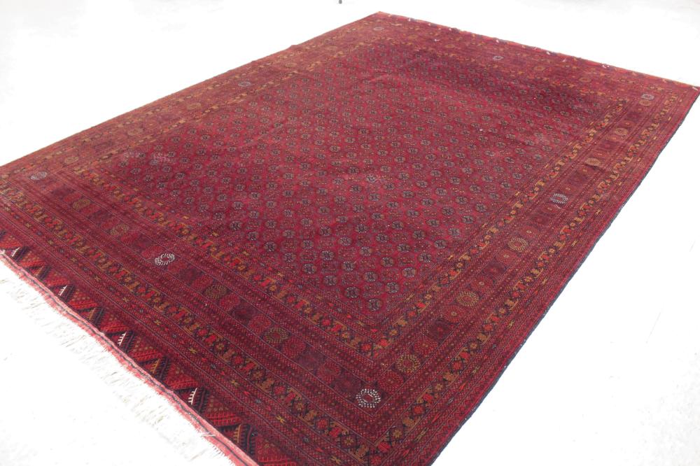 Appraisal: HAND KNOTTED AFGHAN TURKMAN CARPET featuring a field of Turkman