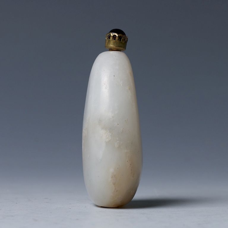 Appraisal: WHITE JADE PEBBLE FORM SNUFF BOTTLE QING Of a pebble